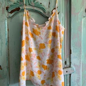 White tank top with yellow and orange flowers on it